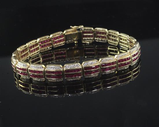 A modern 18ct yellow gold, ruby and diamond line bracelet, 19cm.